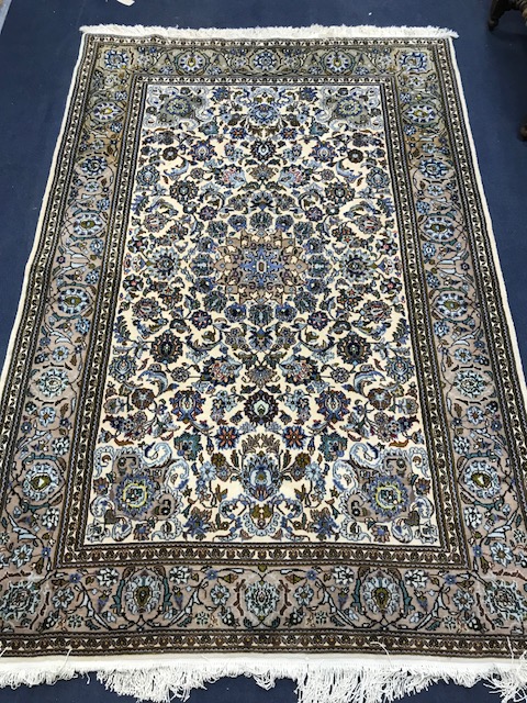 An ivory ground rug 210 x 139cm